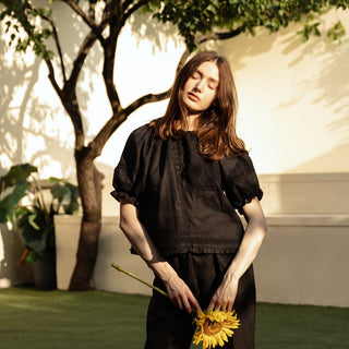 Black linen top with short sleeves, open back and lace details