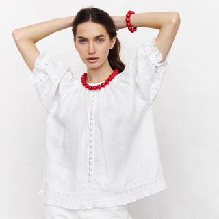 White linen top with puffed sleeves and lace details